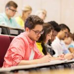 group of students with notebooks in lecture hall