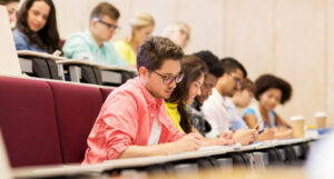 group of students with notebooks in lecture hall