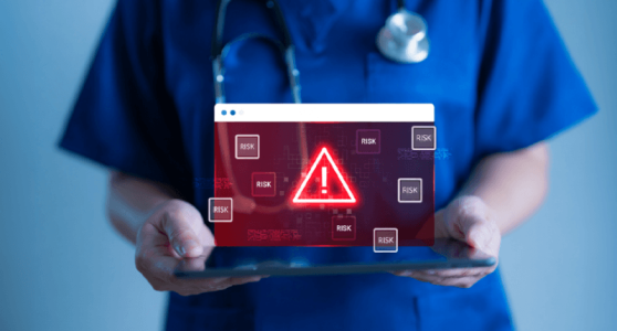 Doctor holding tablet with red warning alert on medical data interface